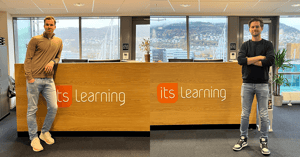 graduates standing in the itslearning reception desk - Bergen office