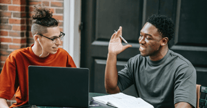 Two men studying and smiling