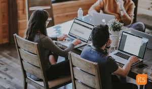 Two people studying with laptops