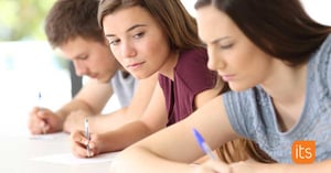 students writing on paper