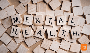 Scrabblebrikker laget av tre som staver Mental Health.